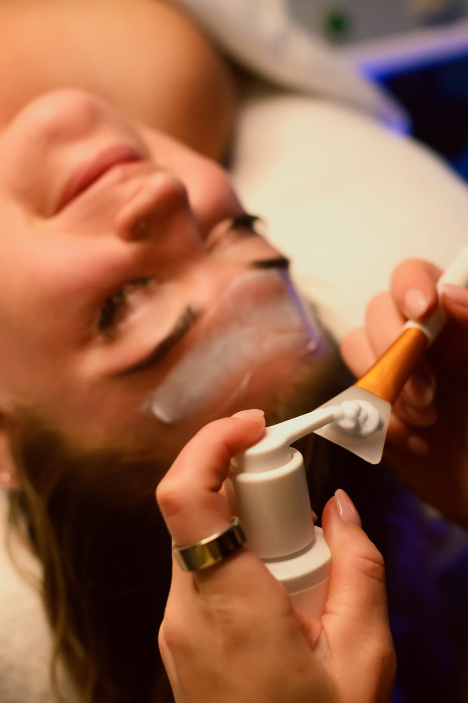 Esthetician applying a treatment with a brush at Level Aesthetics