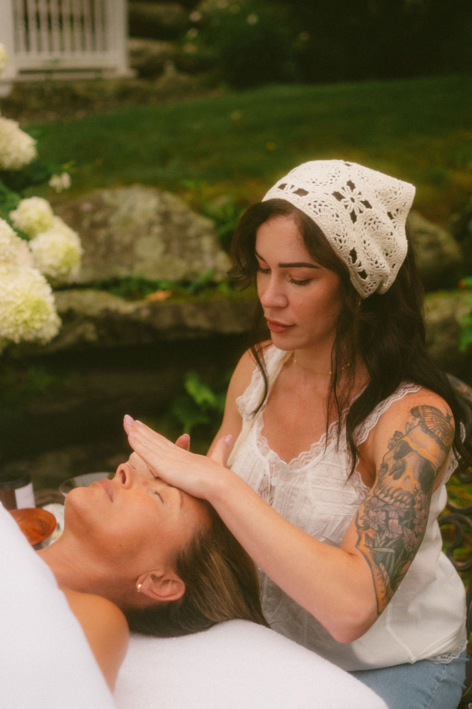 Kristen Kane giving a facial in the garden