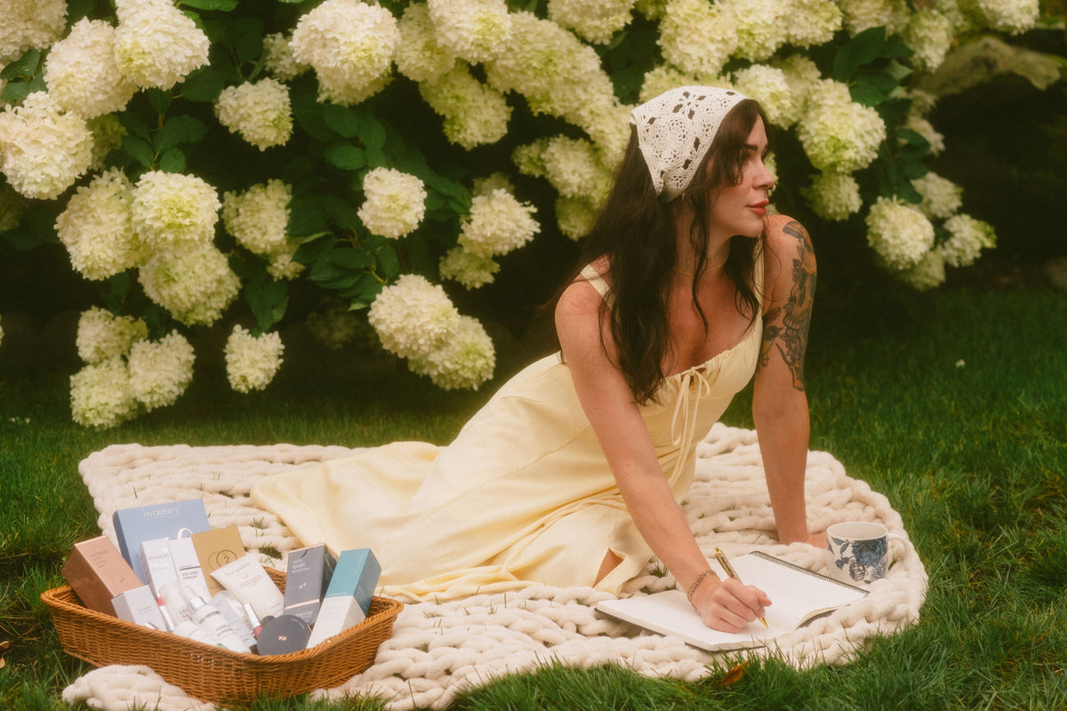 Level Aesthetics skincare products in a basket among white hydrangeas